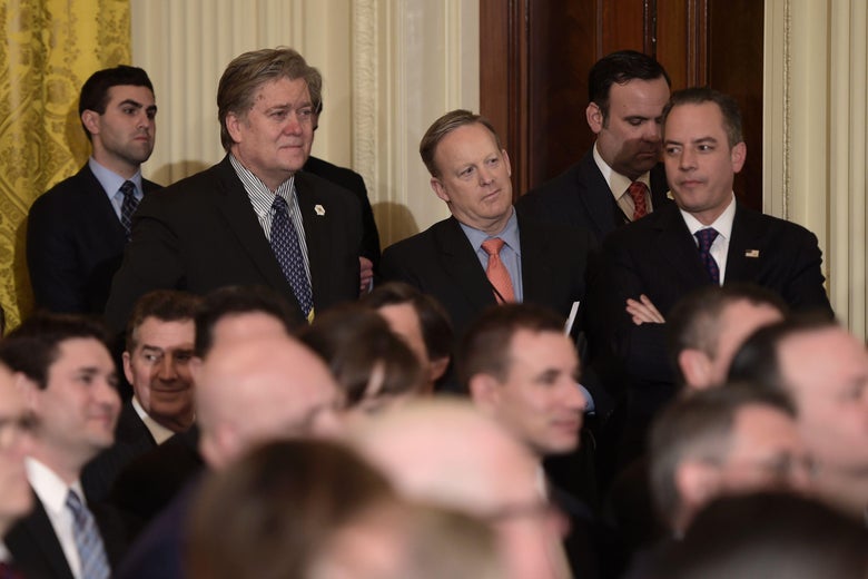 Steve Bannon, Reince Priebus, Sean Spicer standing in the back of a room