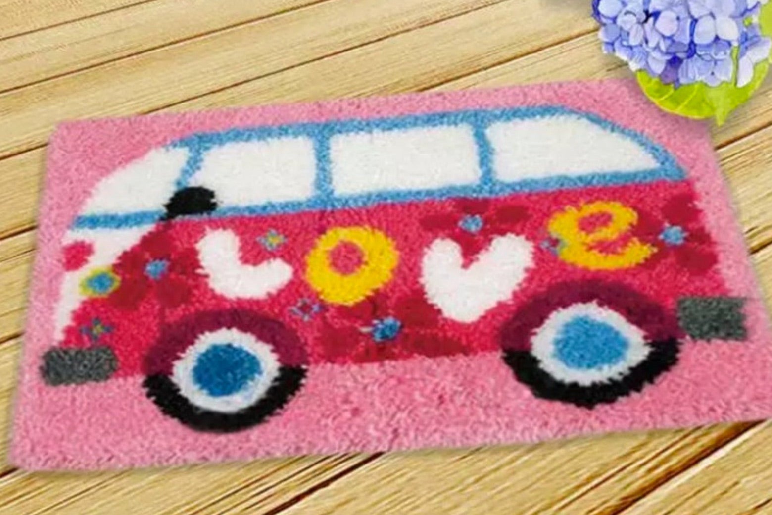 A rug with a bus that says love on the side.
