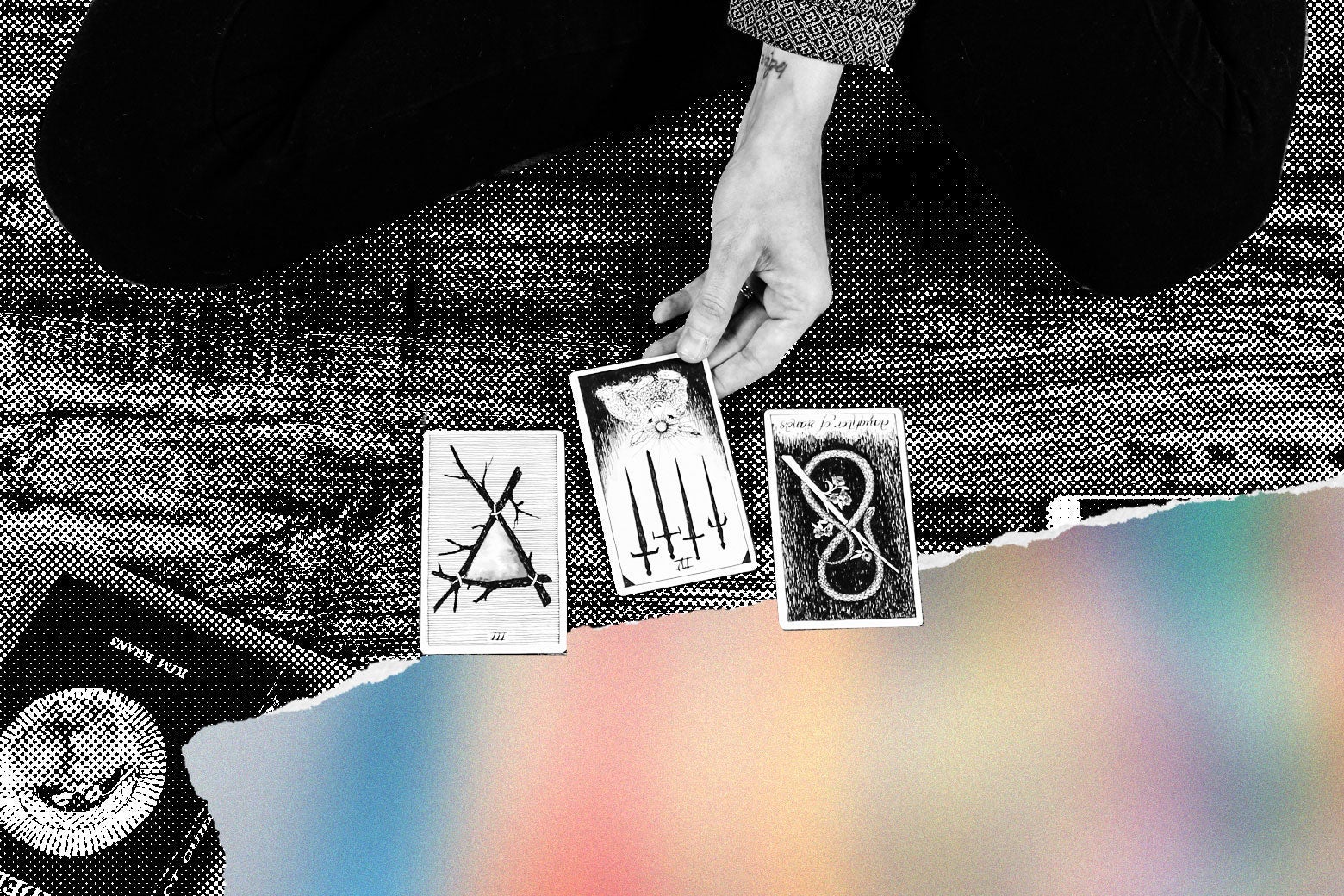 A person sits in front of tarot cards. 