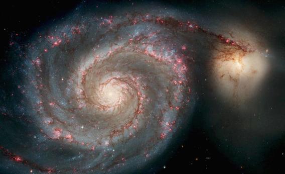 In this handout image released from the Hubble Space Telescope the Whirlpool Galaxy is seen , April 25, 2005 released for the Hubble 15th anniversary.