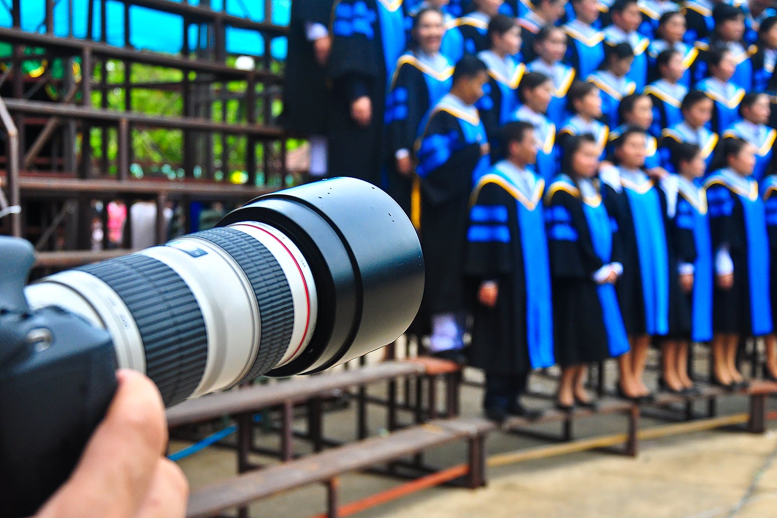 A camera pointing at students graduating.