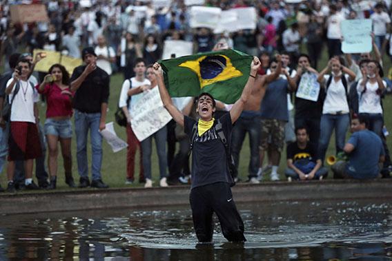 A demonstrator with the Brazilian flag protests against the Confederation's Cup and the government of Brazil's President Dilma Rousseff in Brasilia June 17, 2013.