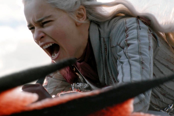 Daenerys Targaryen riding a dragon.