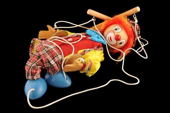 Creepy clown puppet in a tangled pile