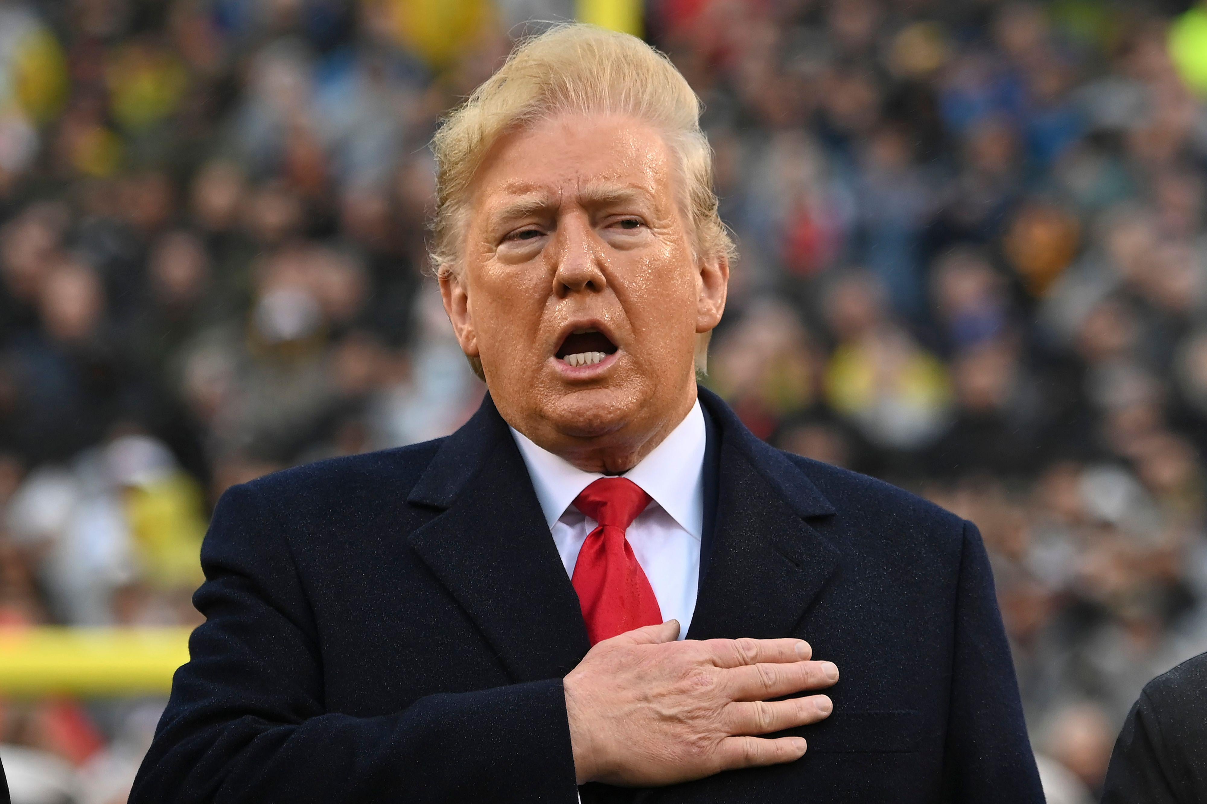 President Donald Trump sings the National Anthem prior to the Army-Navy football game in Philadelphia, Pennsylvania on December 14, 2019.