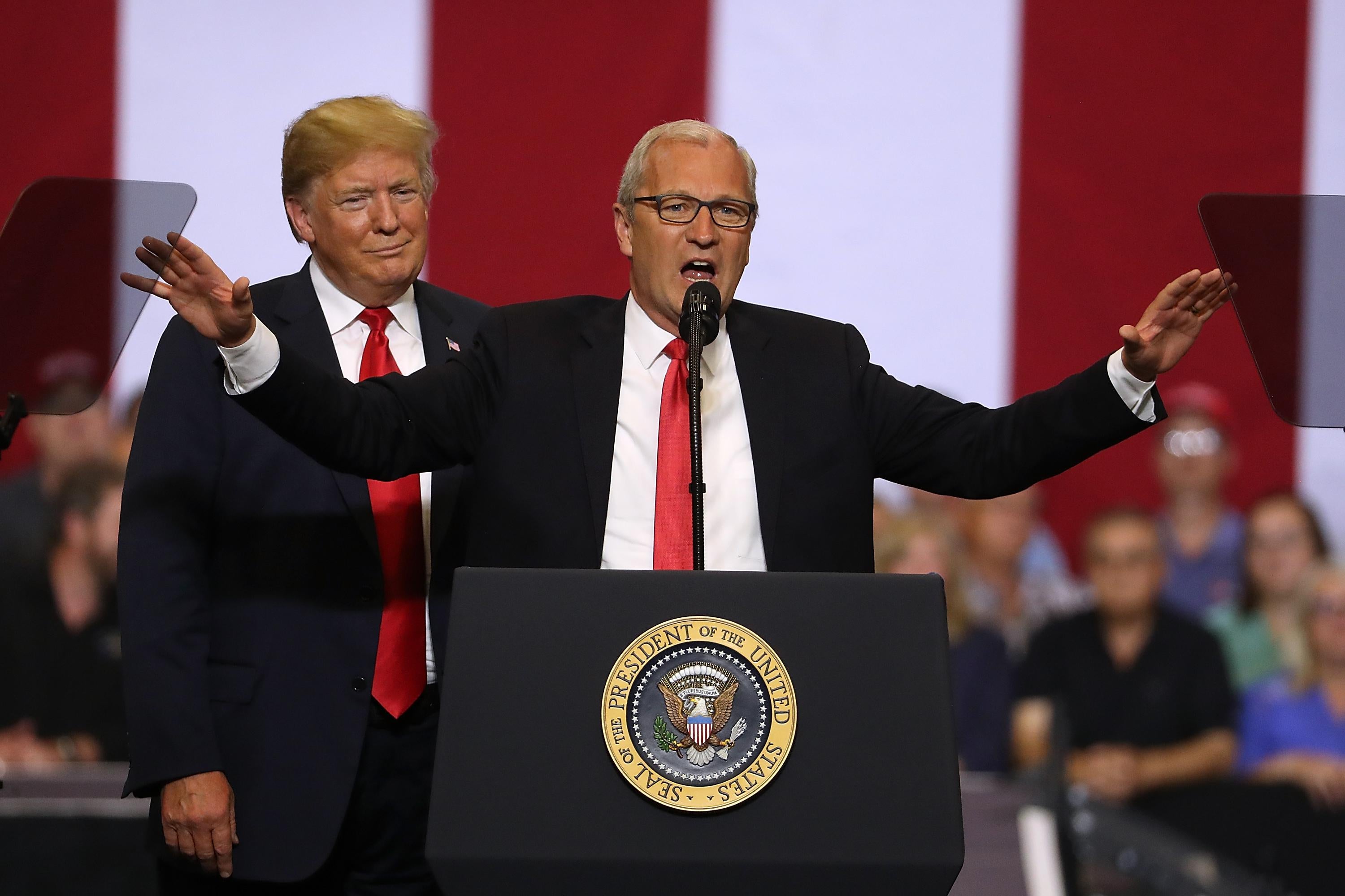 Donald Trump looks on as Kevin Cramer speaks at a June rally in Fargo, North Dakota.