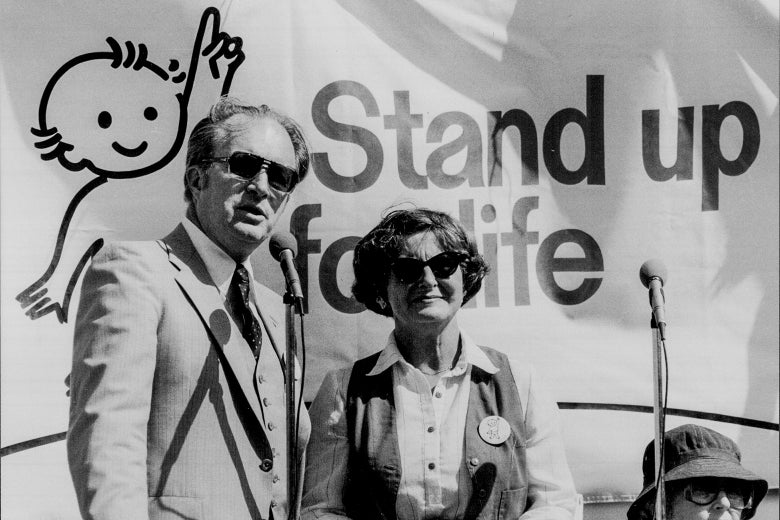 Jack and Barbara Willke at a pro-life march in 1980 — standing in front of a sign that says "Stand Up for Young Life."