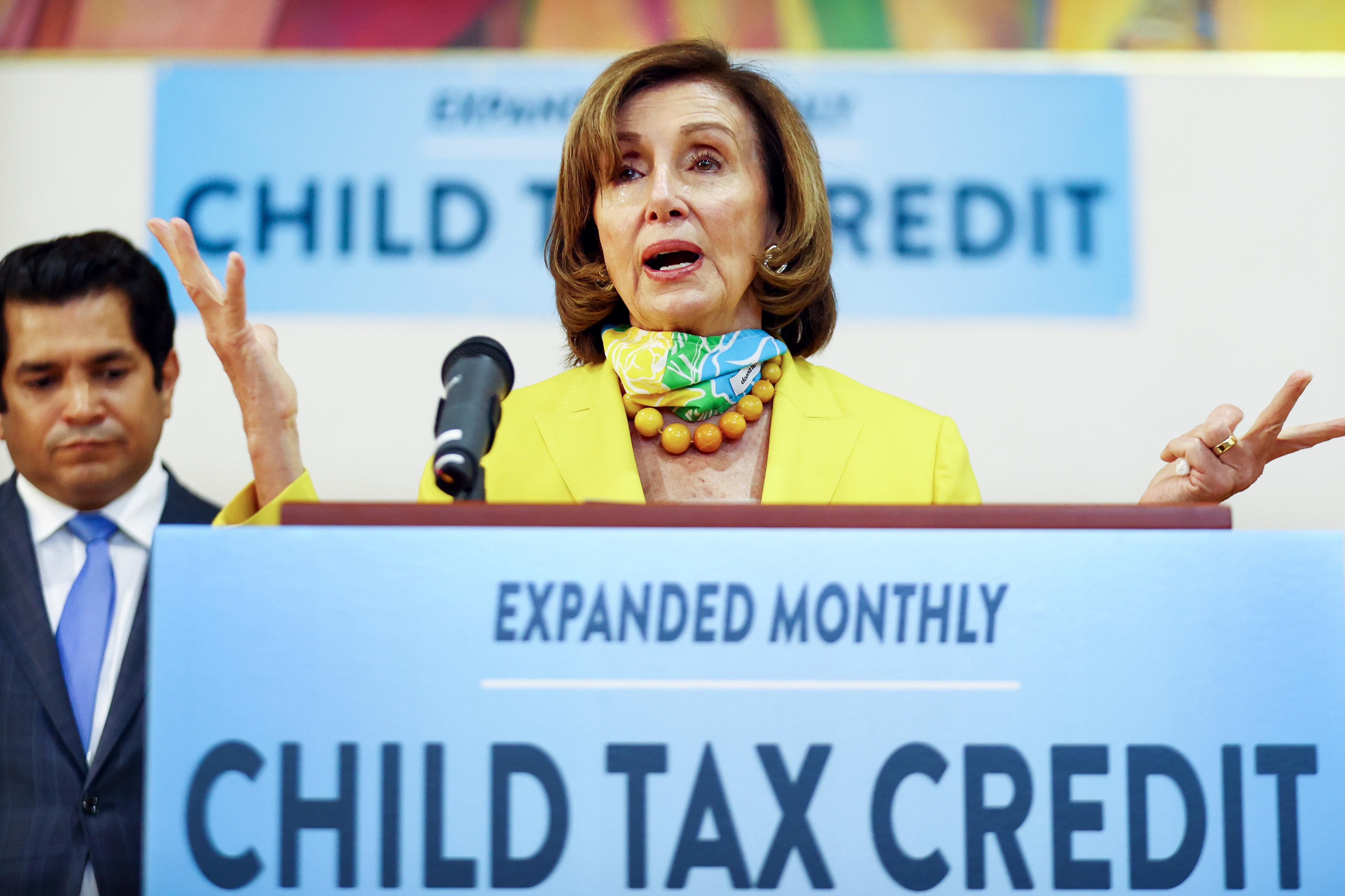 LOS ANGELES, CALIFORNIA - JULY 15: House Speaker Nancy Pelosi (D-CA), C, speaks as Rep. Jimmy Gomez (D-CA) looks on at a press conference on the newly expanded Child Tax Credit at the Barrio Action Youth and Family Center on July 15, 2021 in Los Angeles, California. Many Americans with children began to receive checks today as a result of the passage of the Child Tax Credit legislation. (Photo by Mario Tama/Getty Images)