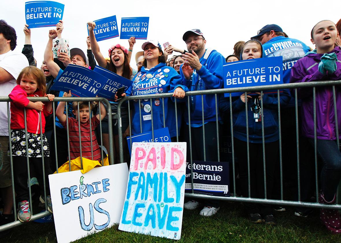 Campaign supporters show their support for Democratic presidential candidate Bernie Sanders as he speaks to them during a campaign rally at the Big Four Lawn park May 3, 2016 in Louisville, Kentucky. 