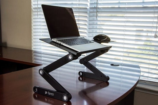 Laptop in adjustable laptop stand.