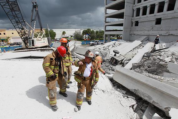  In this handout from Miami-Dade Fire Rescue, Miami-Dade search and rescue look for possible survivors in the rubble of a four-story parking garage that was under construction and collapsed at the Miami Dade College's West Campus on October 10, 2012 in Doral, Florida.