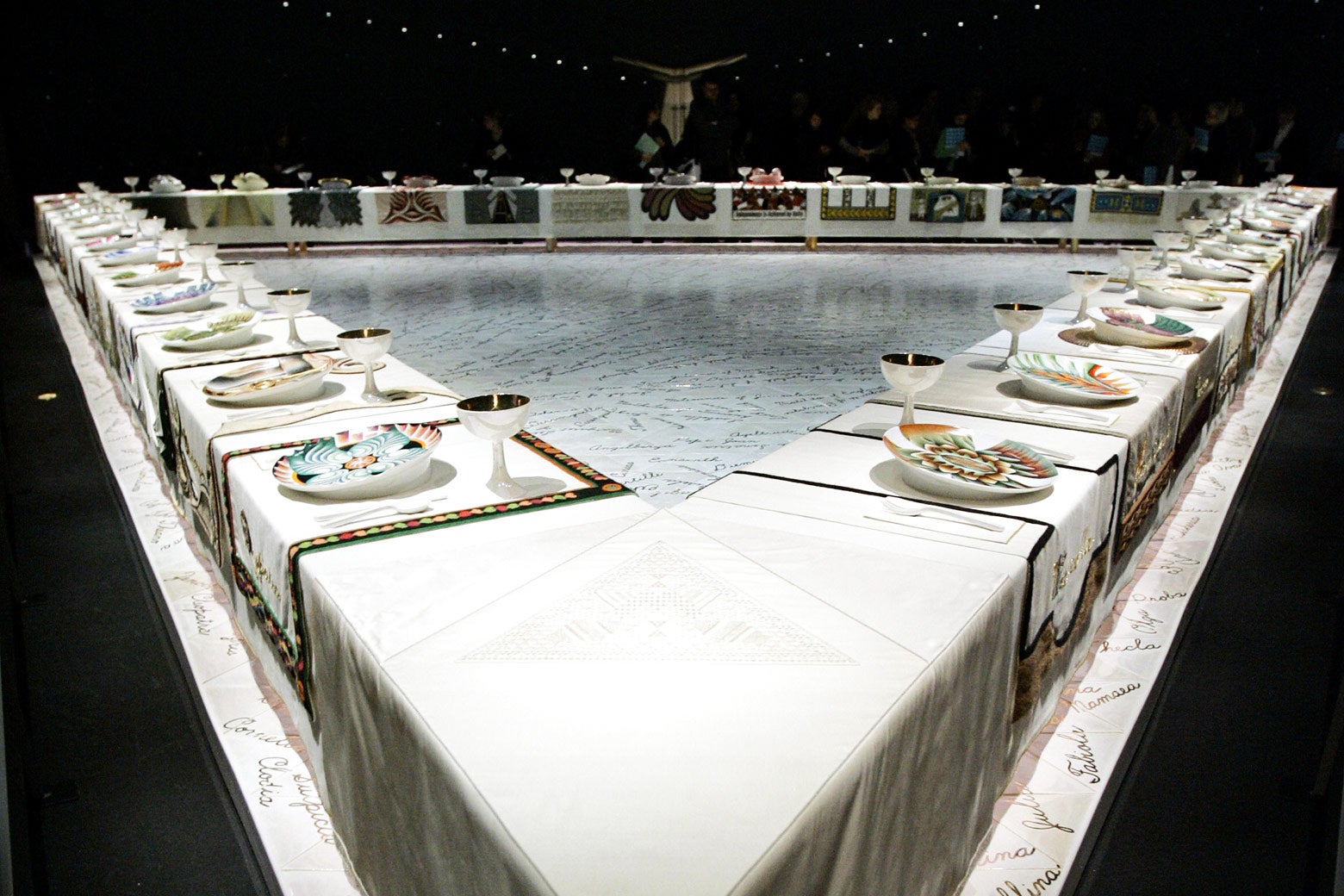 Judy Chicago's The Dinner Party consists of a triangular table set with symbols of female figures throughout history and mythology.