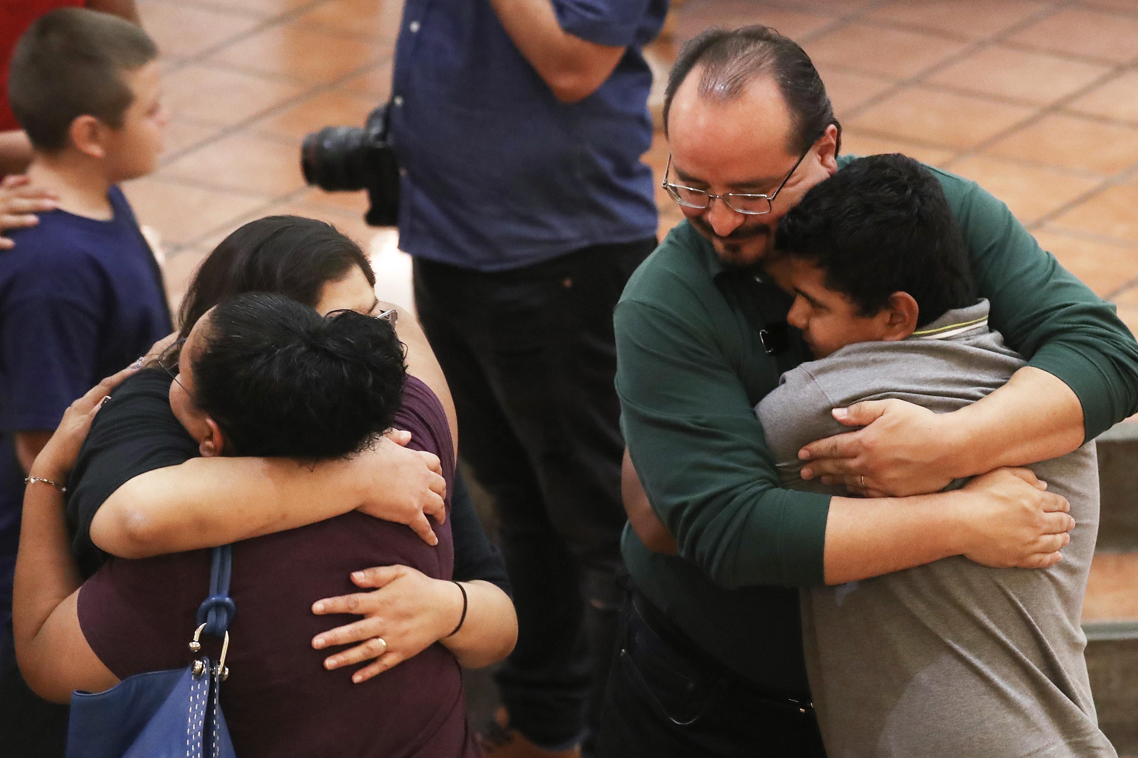 People embrace at the vigil.