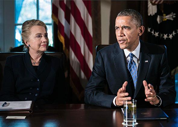 U.S. President Barack Obama (R) speaks as U.S. Secretary of State Hillary Clinton listens at a cabinet meeting at the White House on November 28, 2012 in Washington, DC. 