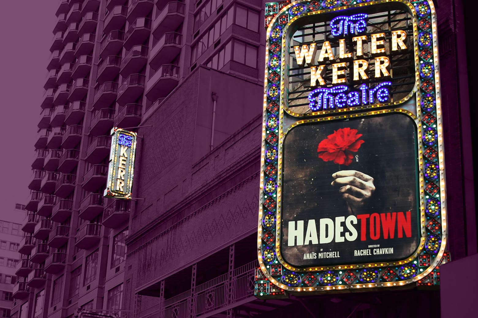 Hadestown on the marquee outside the theater, with a high-rise in the background