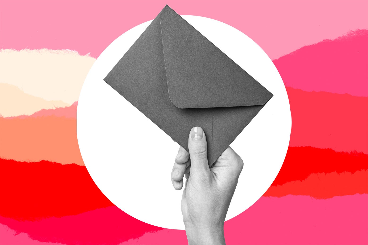 A hand holding an envelope.