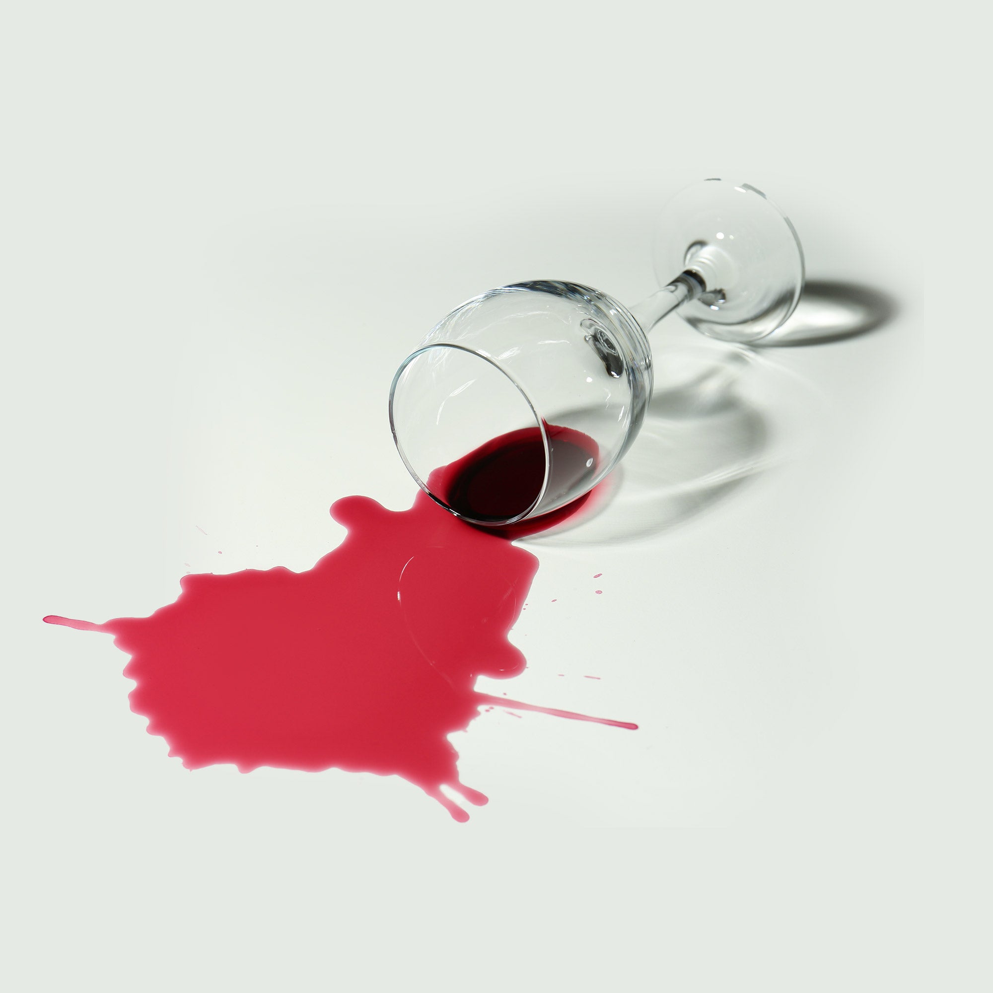 A spilt glass of red wine.