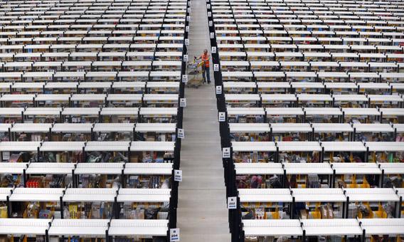A worker collects orders at Amazon's fulfillment center in Rugeley, central England, Dec. 11, 2012.