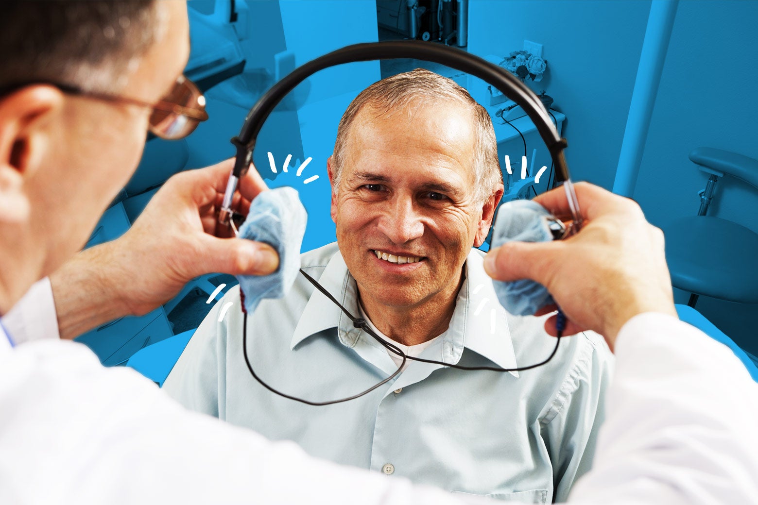 A dentist presents a patient with headphones.