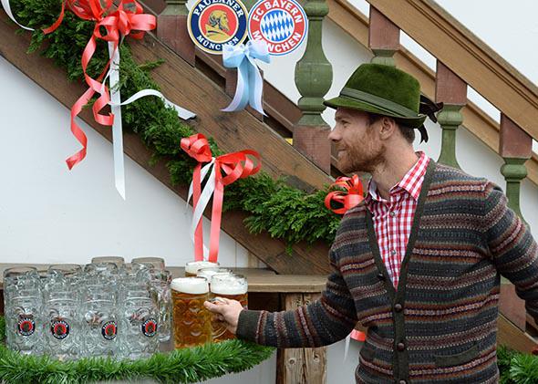 Bayern Munich’s midfielder Xabi Alonso grabs a Paulaner on arrival for the traditional visit of the football club to the Oktoberfest beer festival on the Theresienwiese in Munich, on Oct. 5, 2014