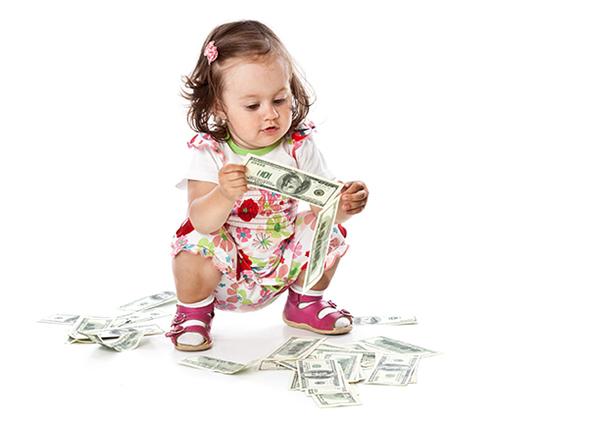 Child plays with $100 bills. 