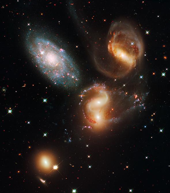 Three of the galaxies in this famous grouping, Stephan's Quintet, are distorted from their gravitational interactions with one another. One member of the group, NGC 7320 (upper left) is actually seven times closer to Earth than the rest.