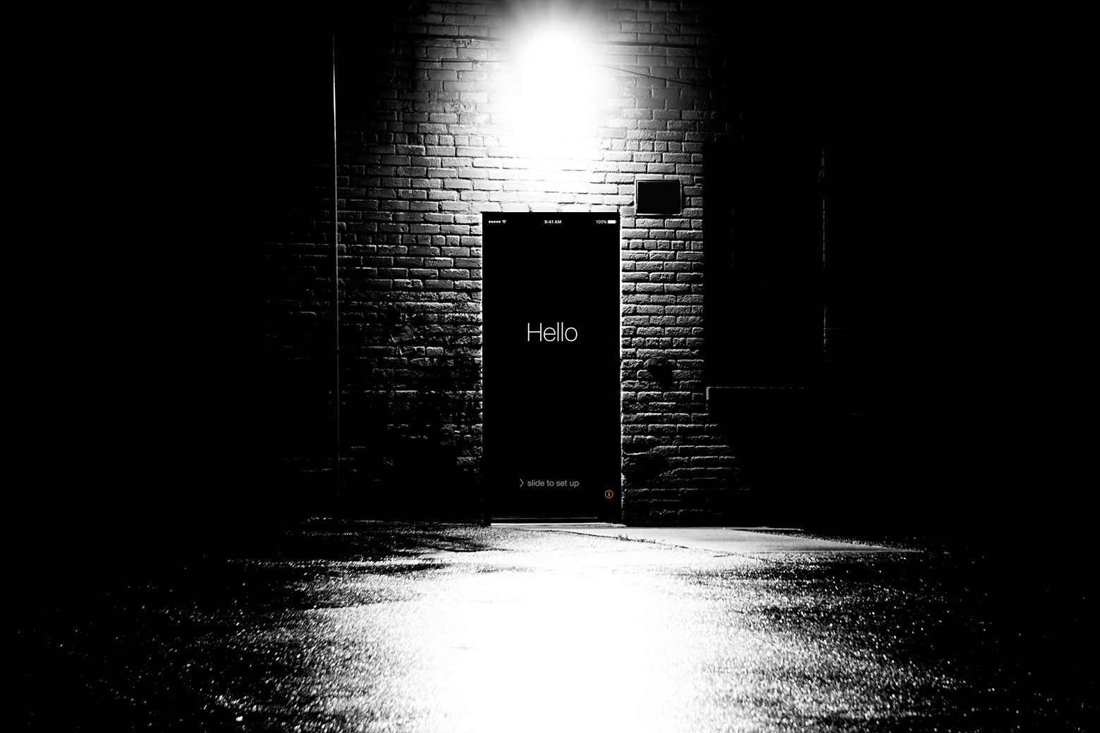 A dark door in a back alley with the Hello intro page of an iPhone.