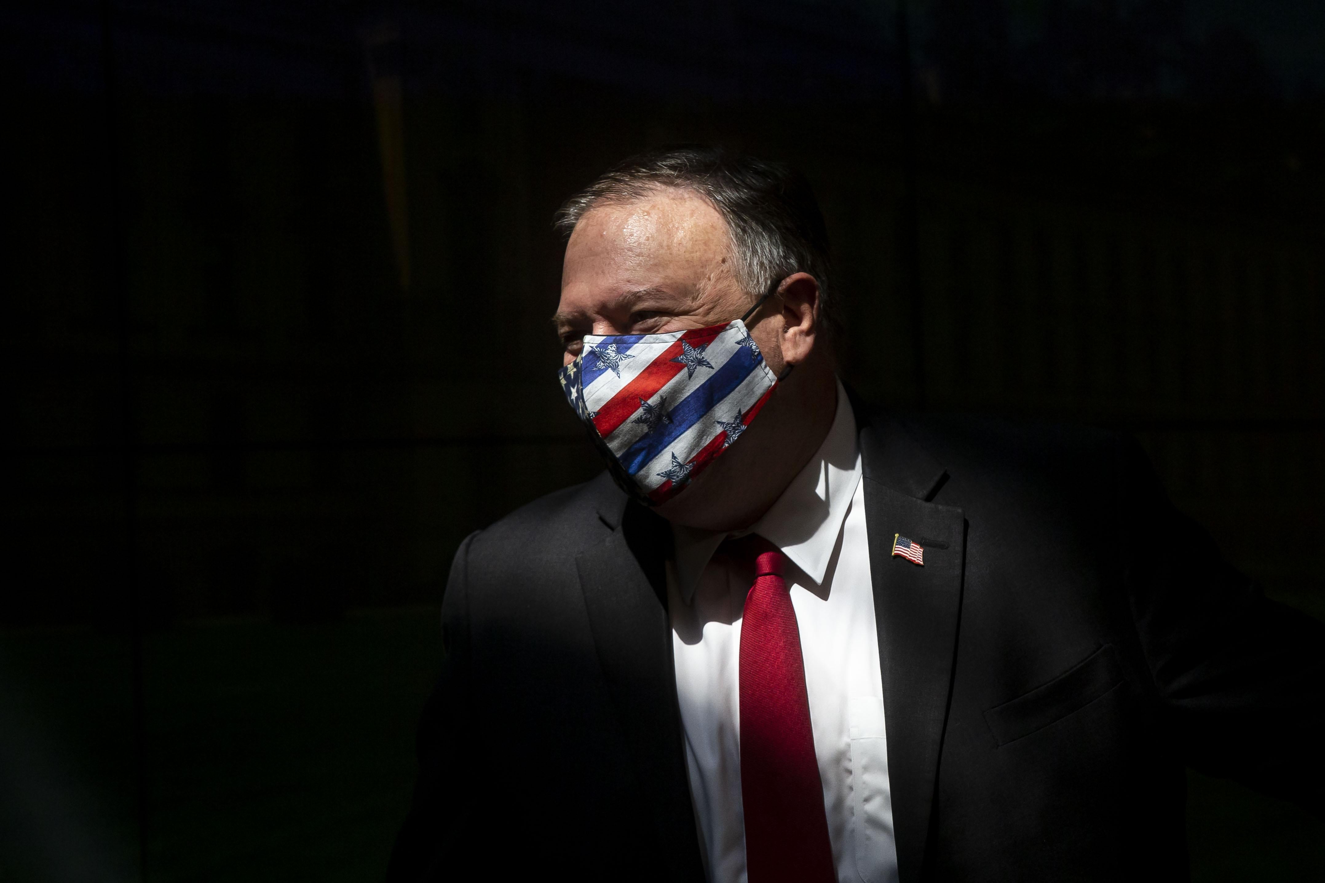 Pompeo wearing a stars-and-stripes mask against a black background. 