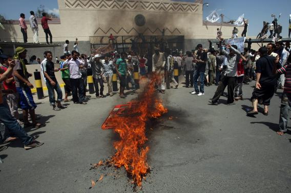 Yemeni protesters gather around fire during a demonstration outside the US embassy in Sanaa over a film mocking Islam on Thursday.