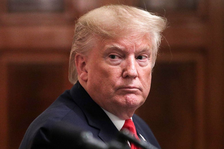 Donald Trump, wearing a red tie.