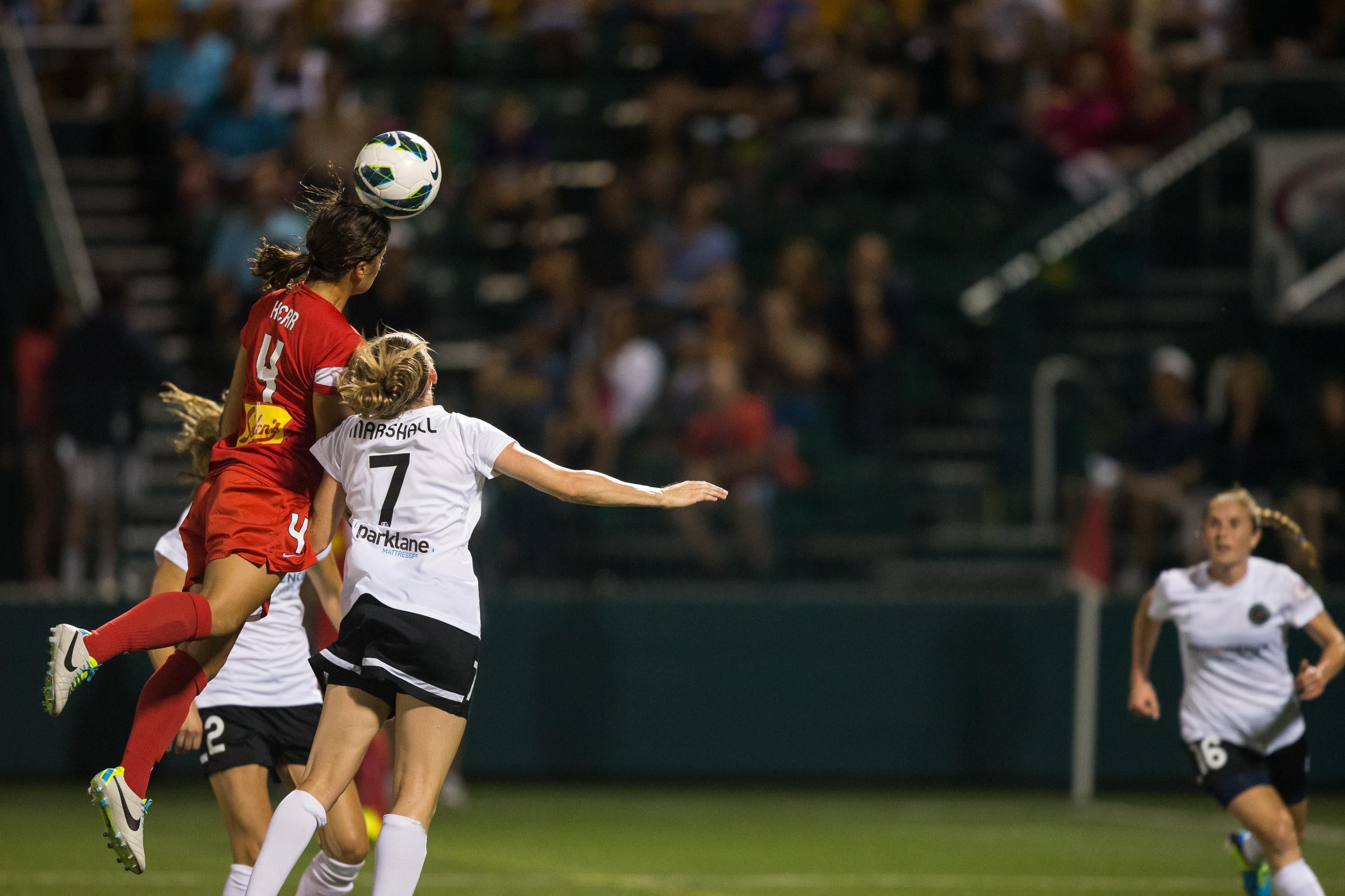 Samantha Kerr #4 of Western New York Flash heads the ball over Portland Thorns FC's Nikki Marshall #7 and Christine Sinclair #12 in the National Women's Soccer League Championship at Sahlen's Stadium August 31, 2013 in Rochester, New York.