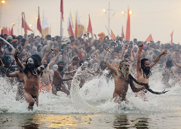 Sadhus run into the Sangham during the Kumbh Mela in Allahabad, India, on Jan. 14, 2013.