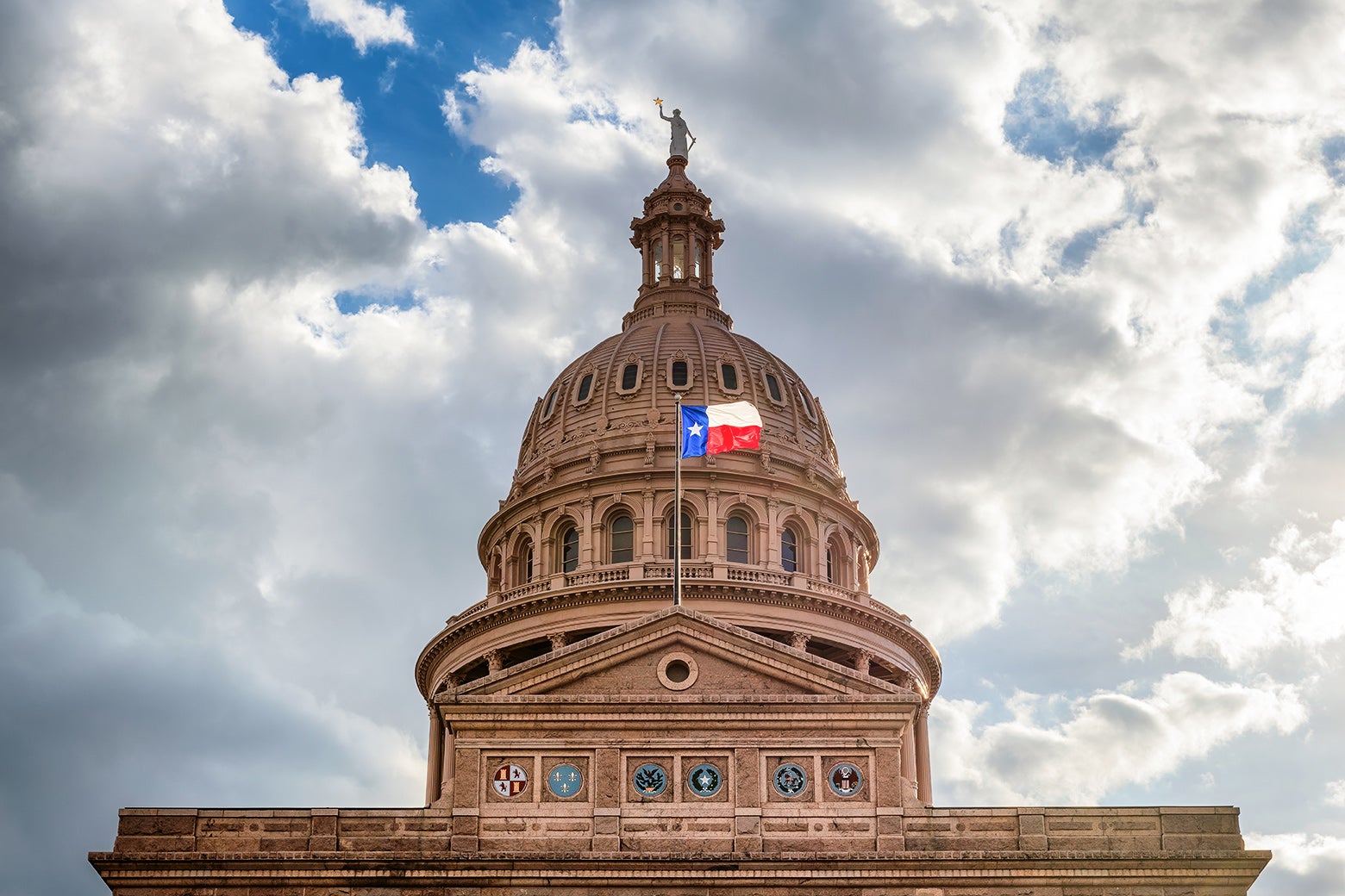 The pink granite exterior of the Texas Capitol building and rotunda.