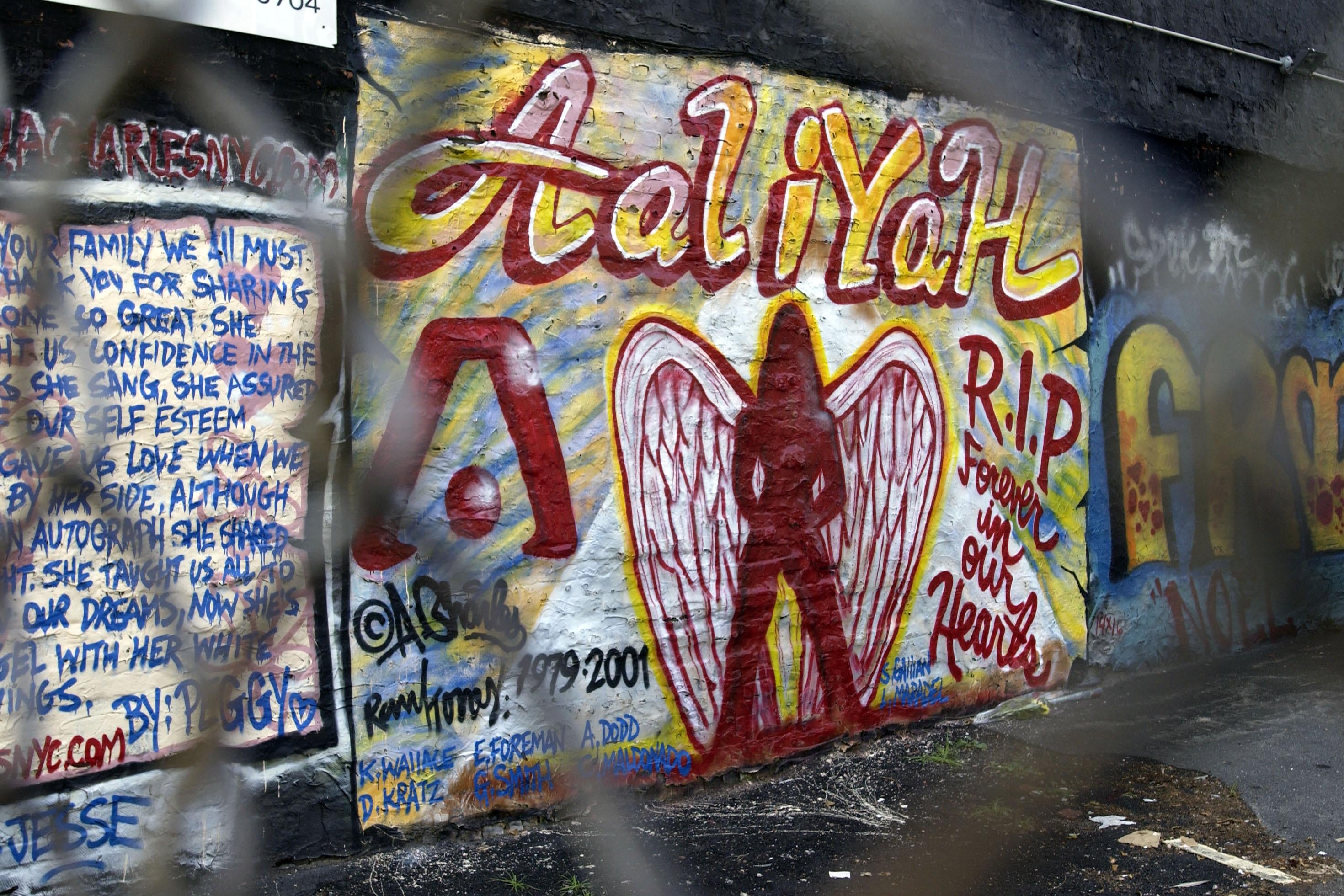 A memorial mural to Aaliyah is seen through a fence.