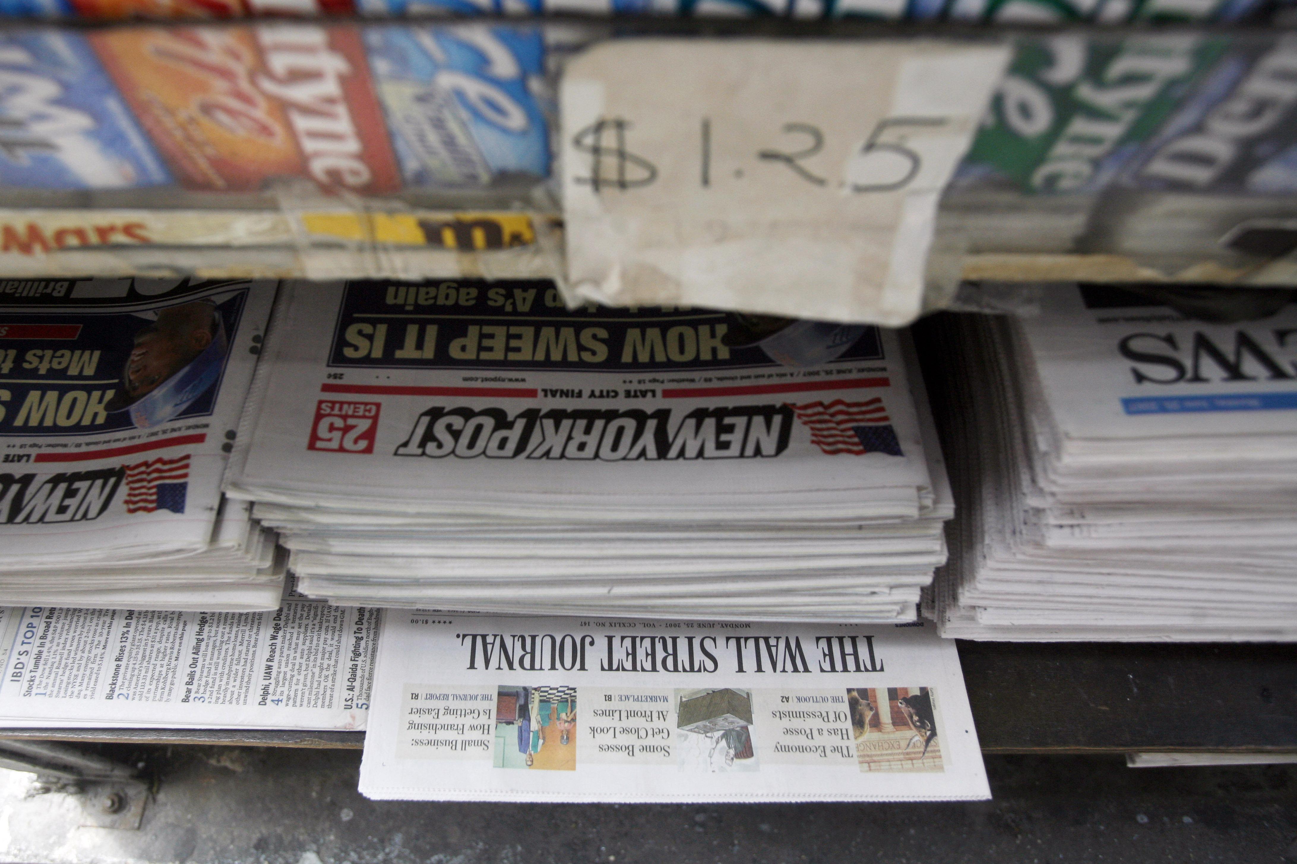 Copies of the New York Post sit on display at a newsstand.