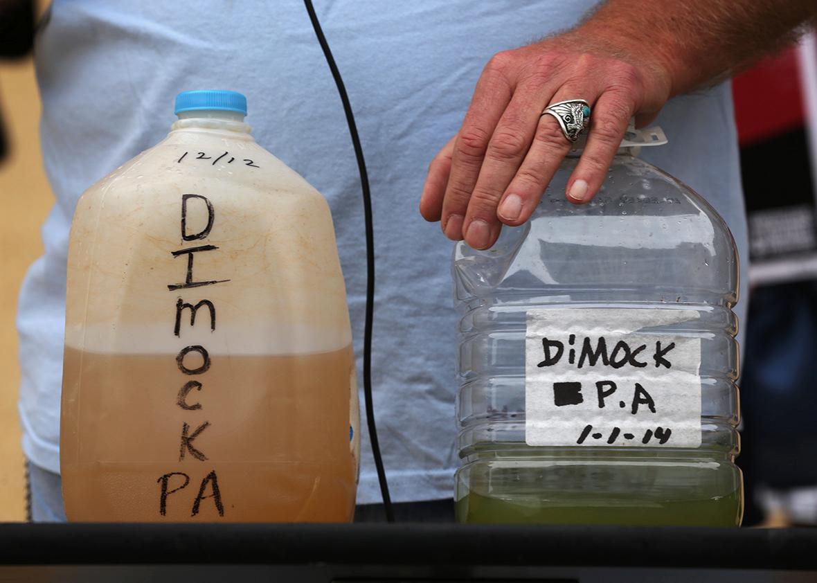 Ray Kemble of Dimock, Pennsylvania, show water samples collected from Dimock, Pennsylvania during a rally on fracking-related water investigations October 10, 2014 outside EPAs Headquarters in Washington, DC. 