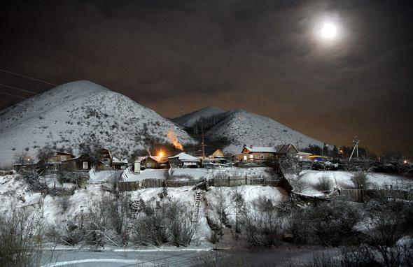 The moon shines above the Siberian village of Bazaikha near Krasnoyarsk January 2, 2007.  