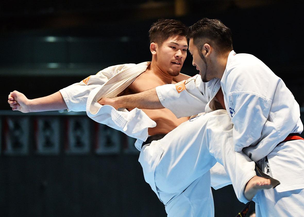 Japan's Yuji Shimamoto (L) and his compatriot Kembu Iriki (R) fight during the men's final match of the 11th World Karate Championship in Tokyo on November 1, 2015. 