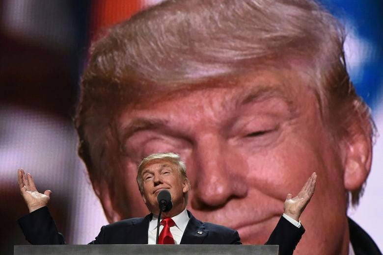 Donald Trump raises his hands in front of a picture of Donald Trump.
