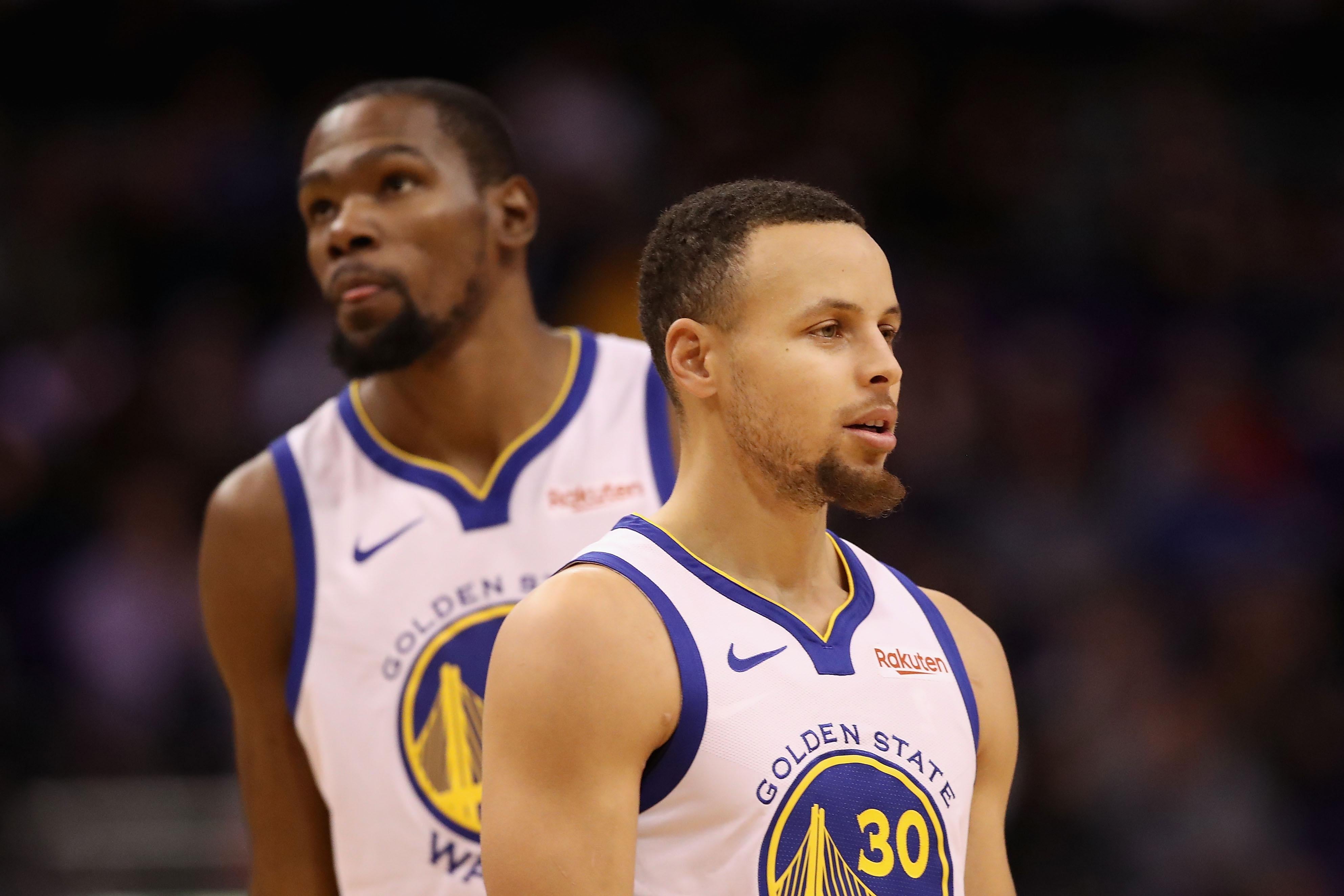 PHOENIX, ARIZONA - FEBRUARY 08:  Stephen Curry #30 and Kevin Durant #35 of the Golden State Warriors during the first half of the NBA game against the Phoenix Suns at Talking Stick Resort Arena on February 08, 2019 in Phoenix, Arizona. (Photo by Christian Petersen/Getty Images)