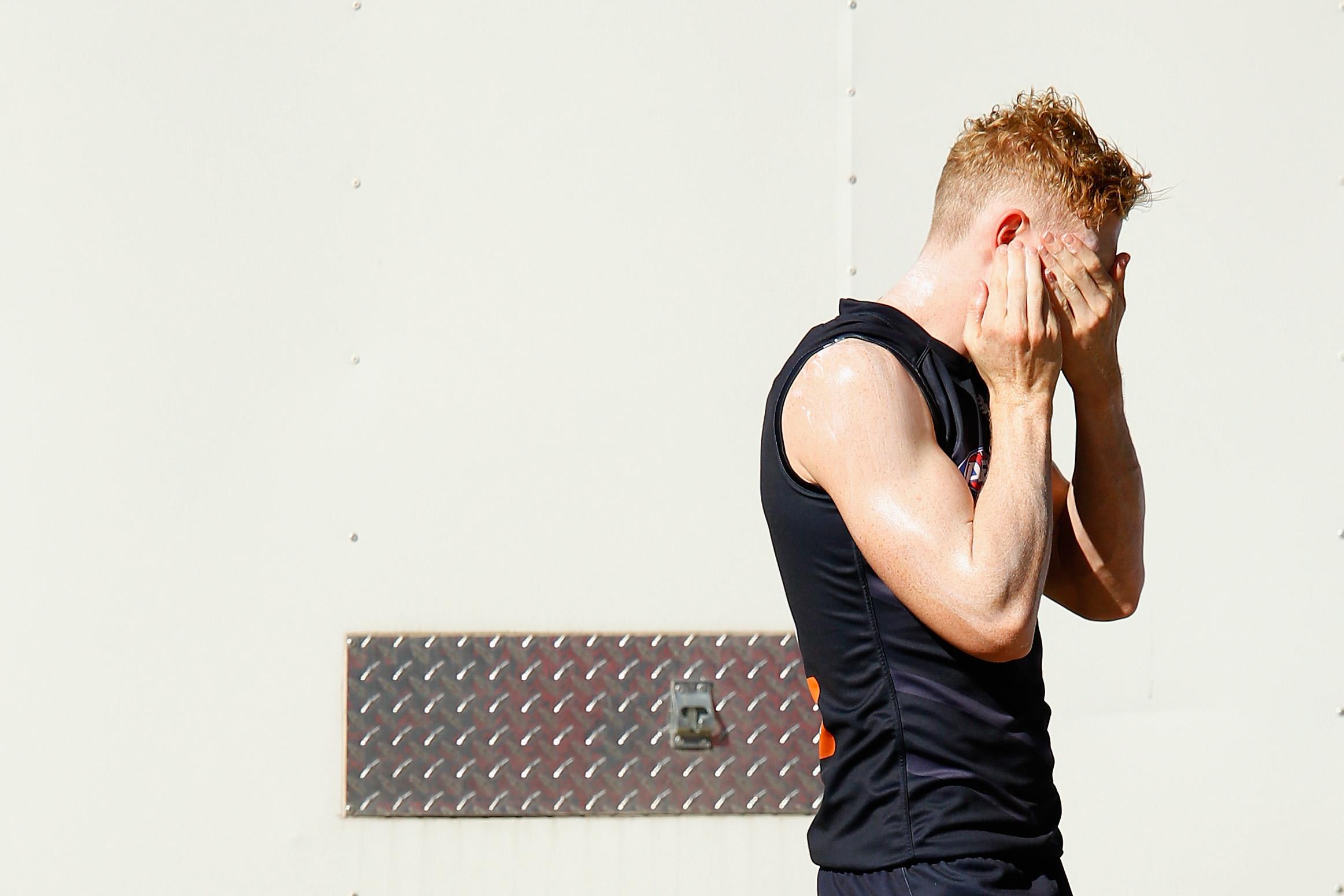 Clayton Oliver of the Demons applies sunscreen during a Melbourne Demons AFL training session at Gosch's Paddock on March 7, 2018 in Melbourne, Australia.