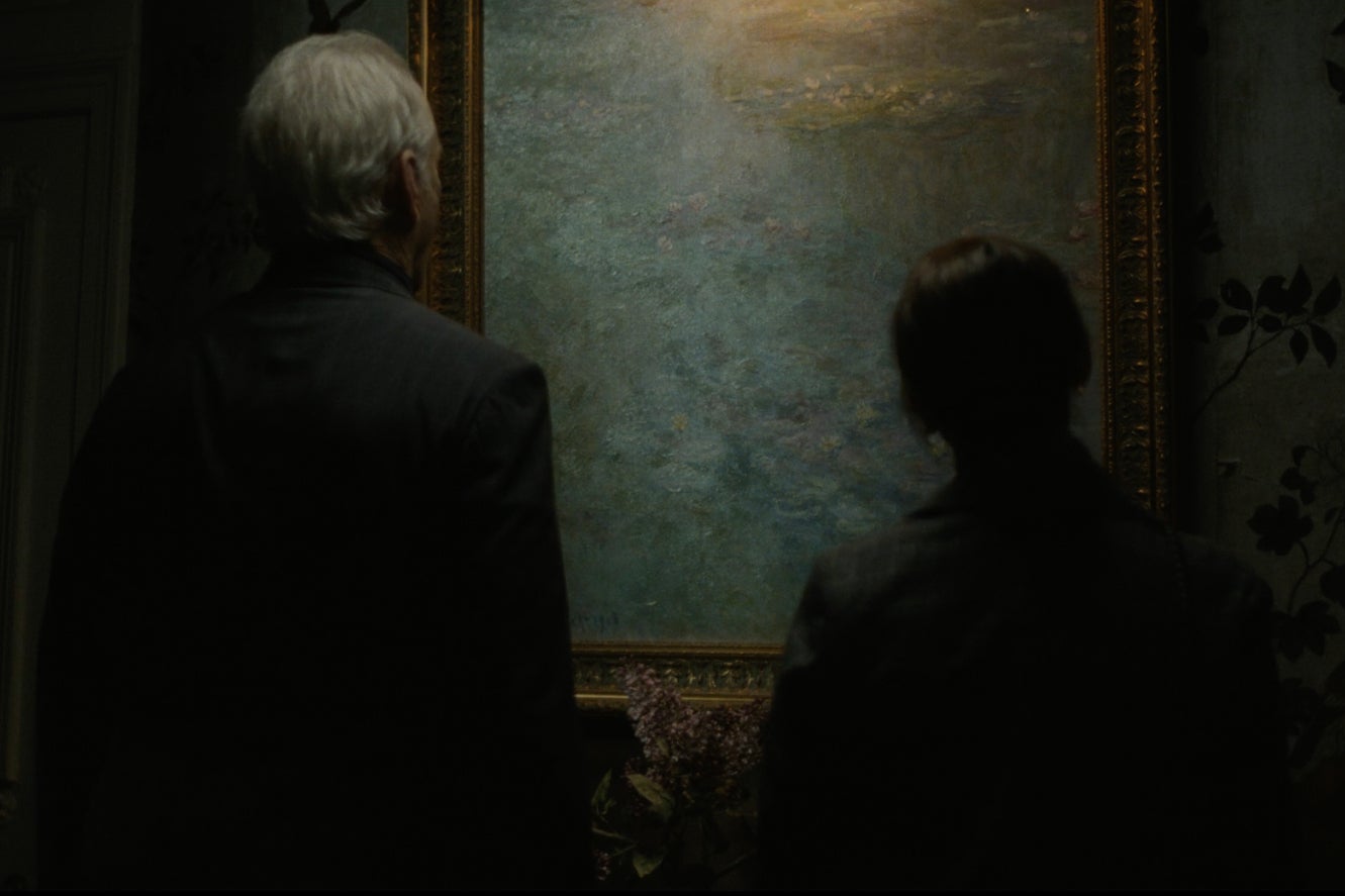 Bill Murray and Rashida Jones stand in front of and contemplate a Monet painting