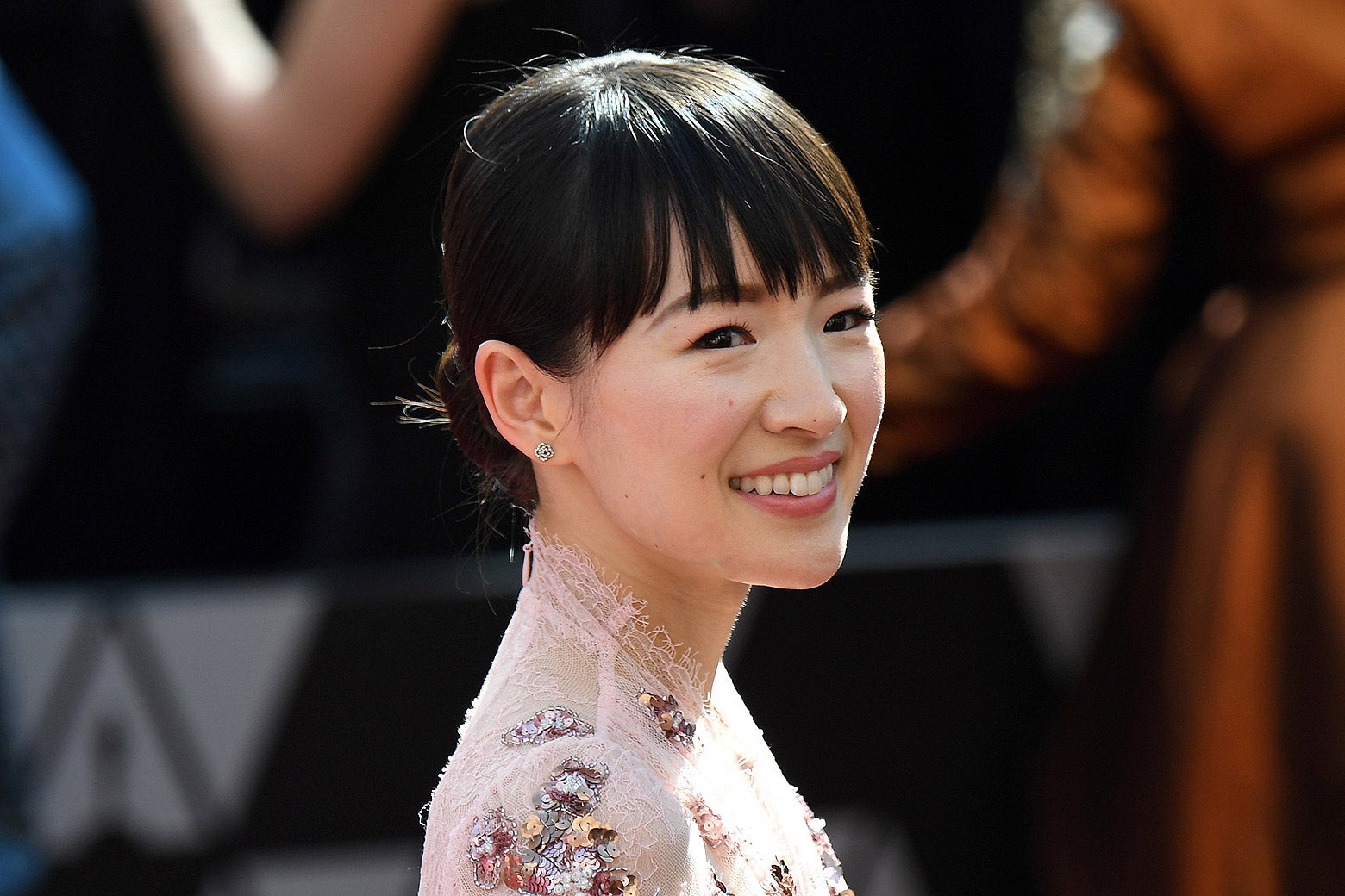 Marie Kondo smiling on a red carpet.