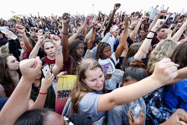 Students of area High Schools rally at Marjory Stoneman Douglas High School after participating in a county wide school walk out in Parkland, Florida on February 21, 2018. 
A former student, Nikolas Cruz, opened fire at Marjory Stoneman Douglas High School leaving 17 people dead and 15 injured on February 14. / AFP PHOTO / RHONA WISE        (Photo credit should read RHONA WISE/AFP/Getty Images)