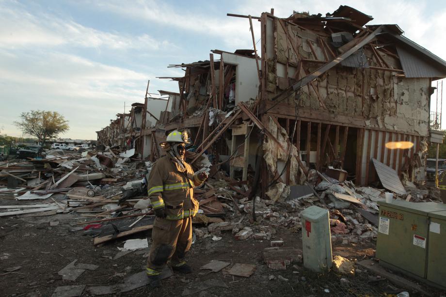 A Valley Mills Fire Department personnel walks among the remains of an apartment complex next to the fertilizer plant that exploded yesterday afternoon on April 18, 2013 in West, Texas.