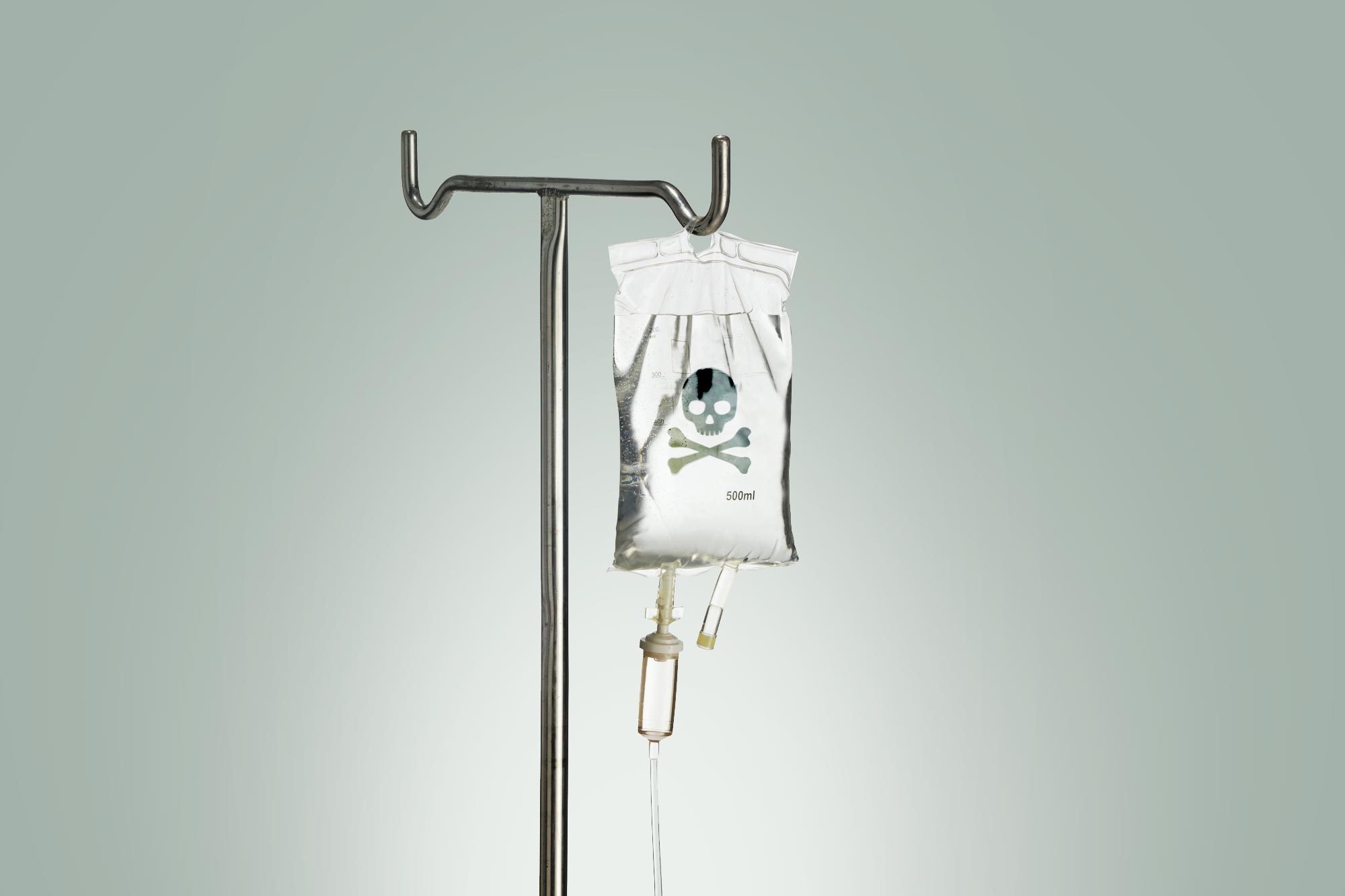 An IV bag with a skull and crossbones on it is pictured against a stark background.