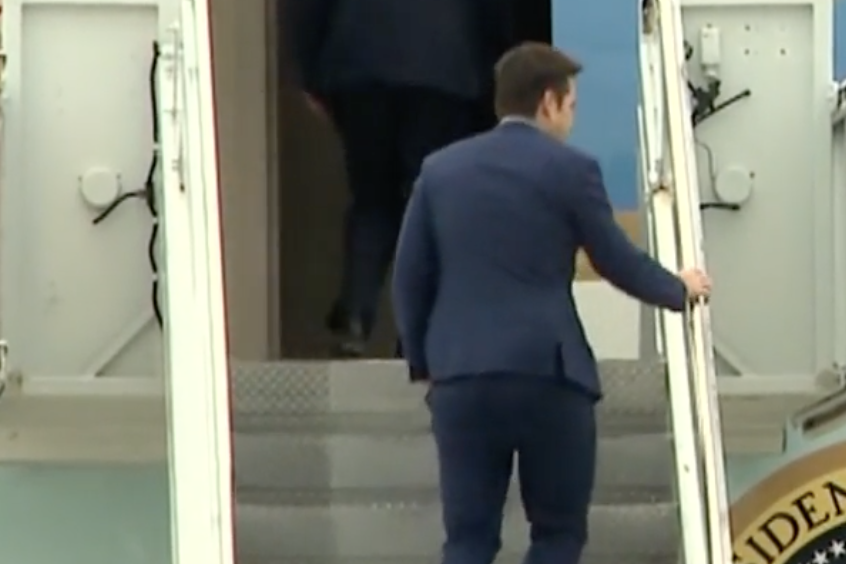 Matt Gaetz walks up stairs to board a plane