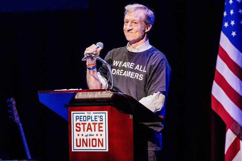Tom Steyer, wearing a shirt that says, "We are all Dreamers," stands at a podium.