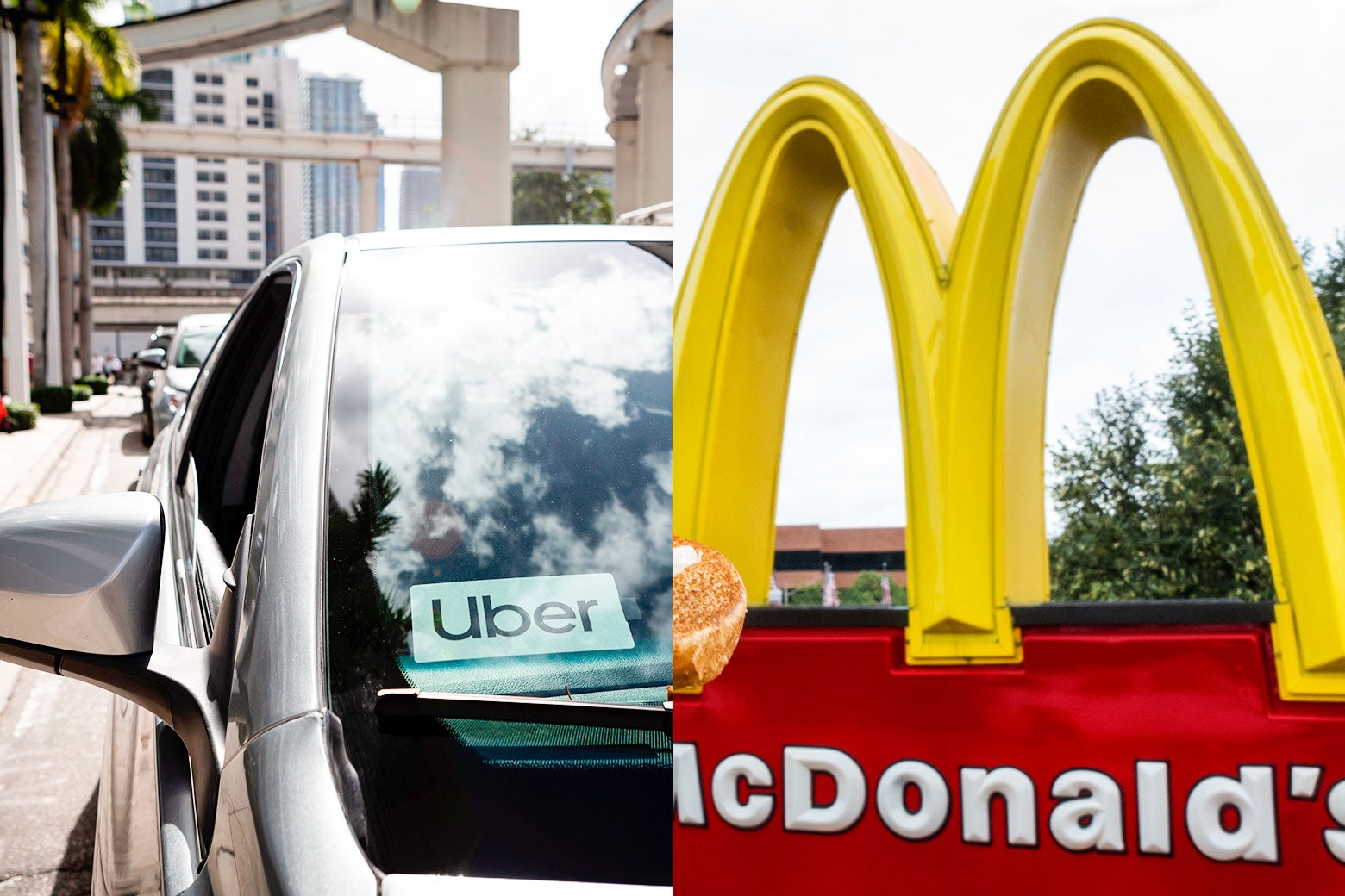 A car with an Uber sticker in the front window and a McDonald's golden arches sign.
