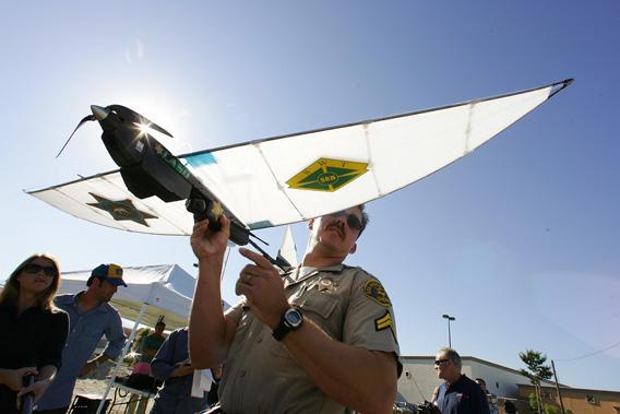 Deputy Troy Sella from the new technology department of the Los Angeles Sheriff's Department (LASD) prepares the SkySeer Unmanned Arial Vehicle (UAV) drone for launch,16 June 2006 during a demonstration flight in Redlands, California. The LASD plans to purchase SkySeer drones to carry out surveillance and rescue operations.